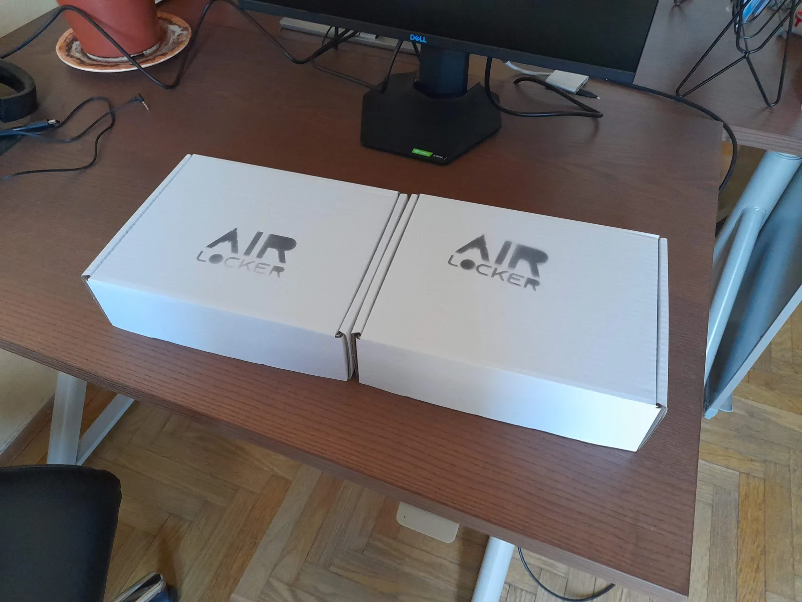 Two closed white AIR LOCKER retail boxes with the logo printed on the lid