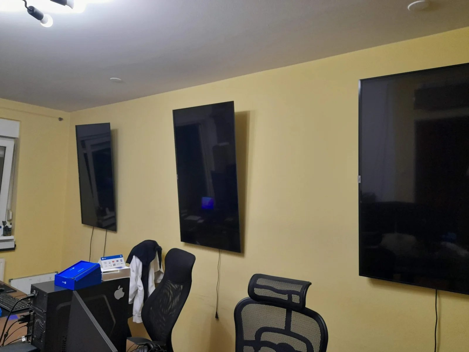 A wall rig with three portrait screens and one landscape, all mounted together